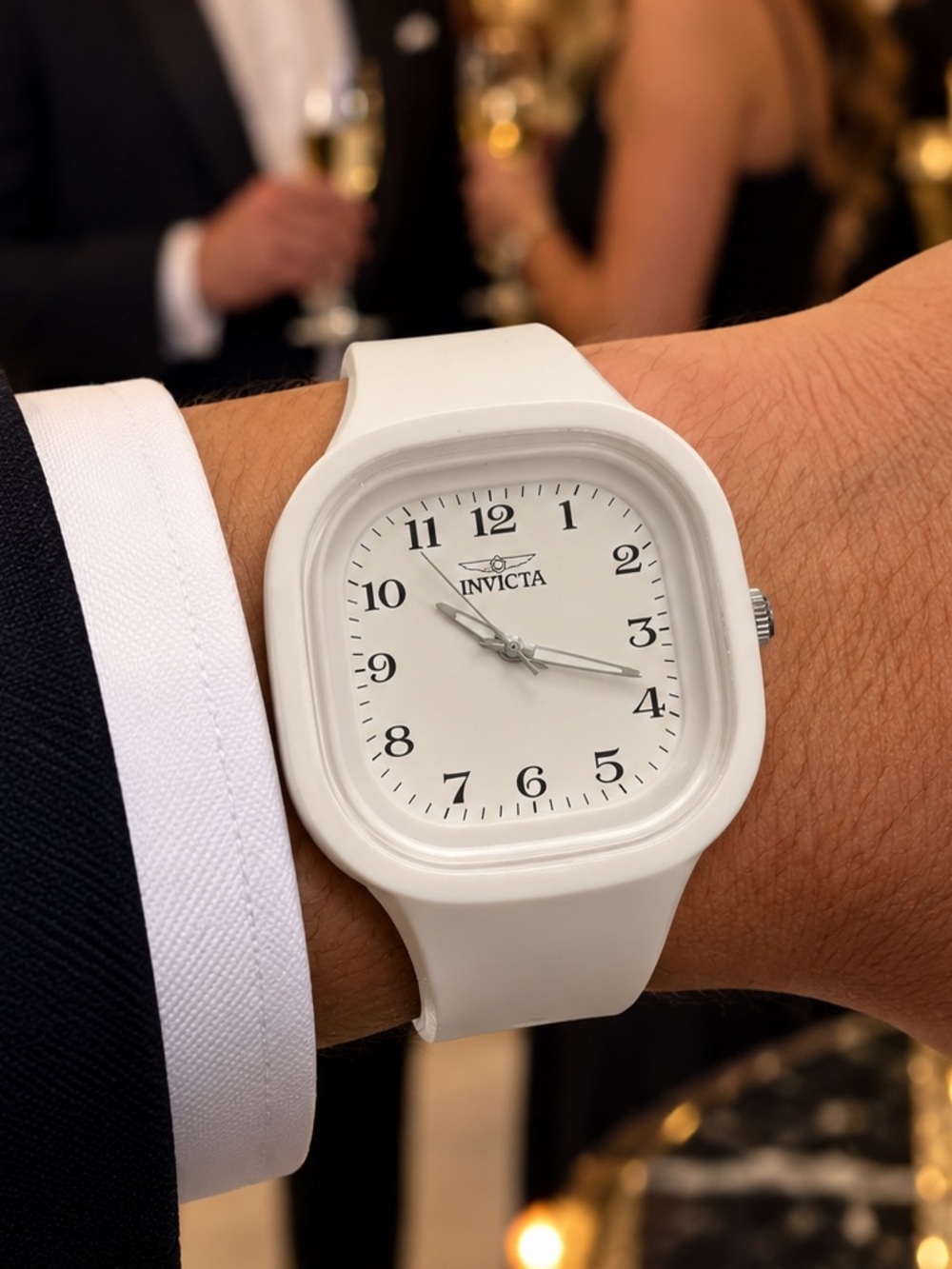 Men’s white watch with black numbers and letters across the
